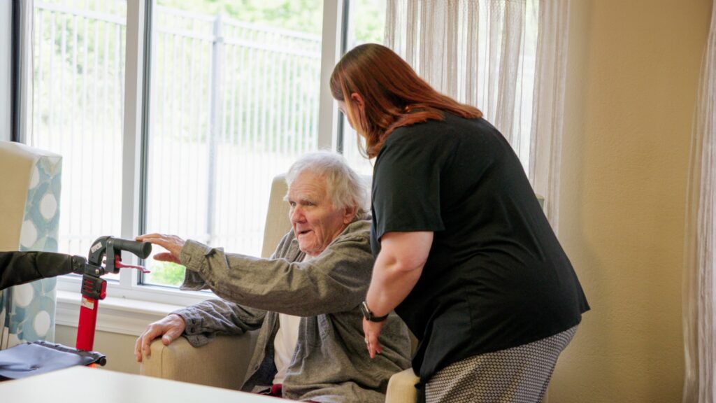 A long term care resident is being assisted by a nurse